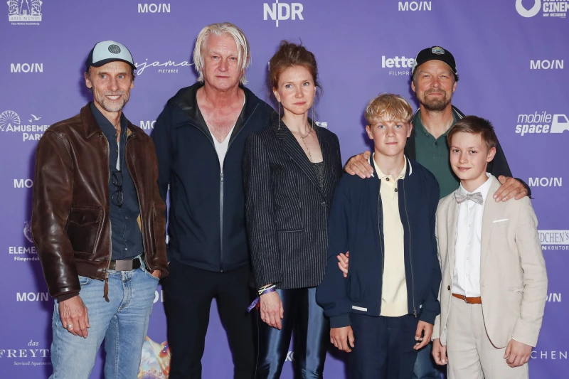 Das Filmteam von Amrum steht vor einer lila Wand.