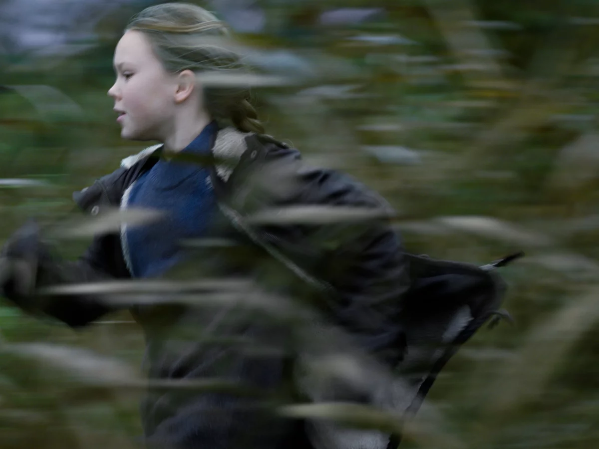 Ein Mädchen rennt durch den Wald